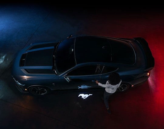 2024 Ford Mustang® Dark Horse™ model with a driver approaching the vehicle | Kline Ford in Winfield KS