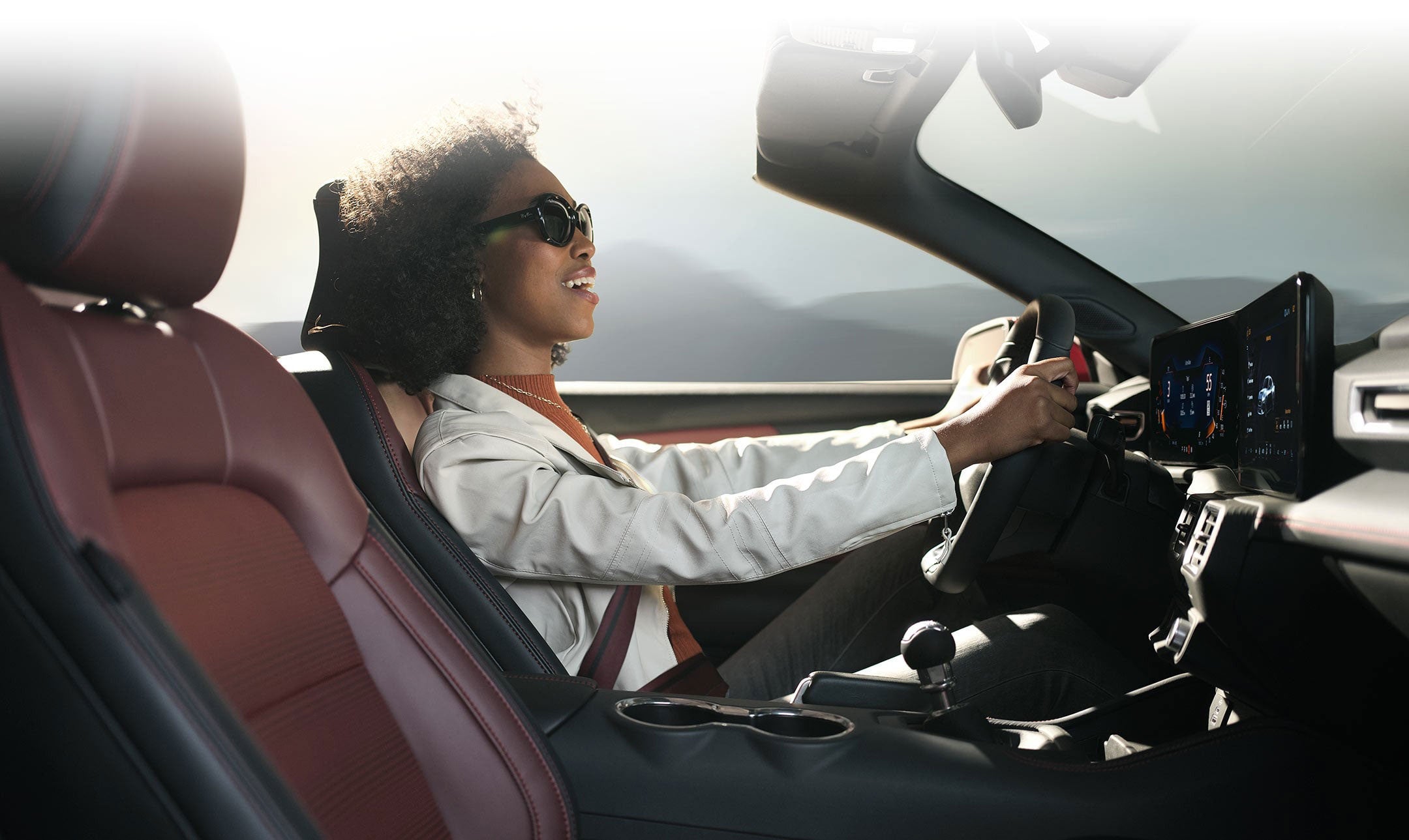 Person sitting in the driver’s seat of a 2024 Ford Mustang® convertible | Kline Ford in Winfield KS